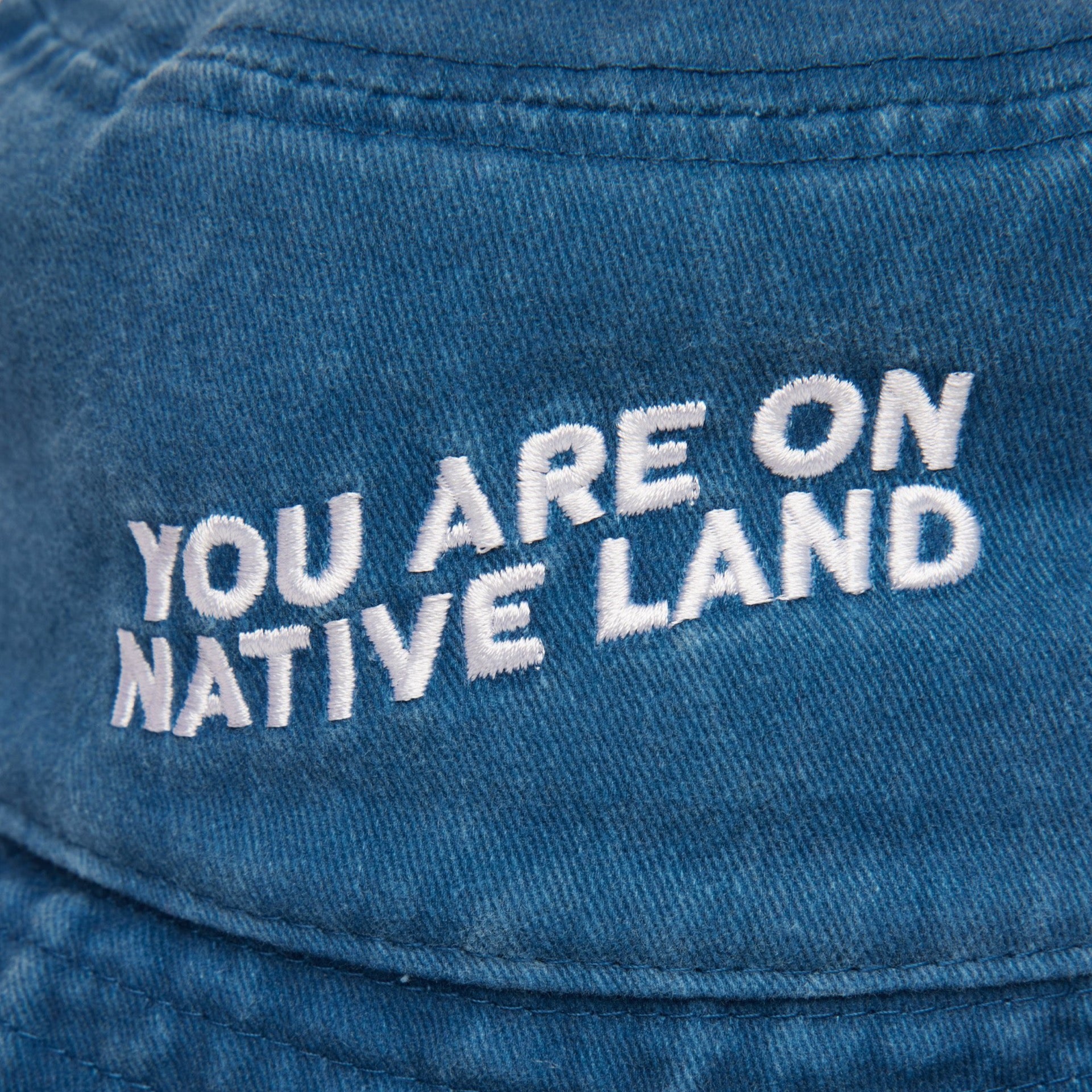 'YOU ARE ON NATIVE LAND' BUCKET HAT